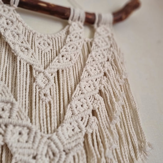 Macramé decoration on wood